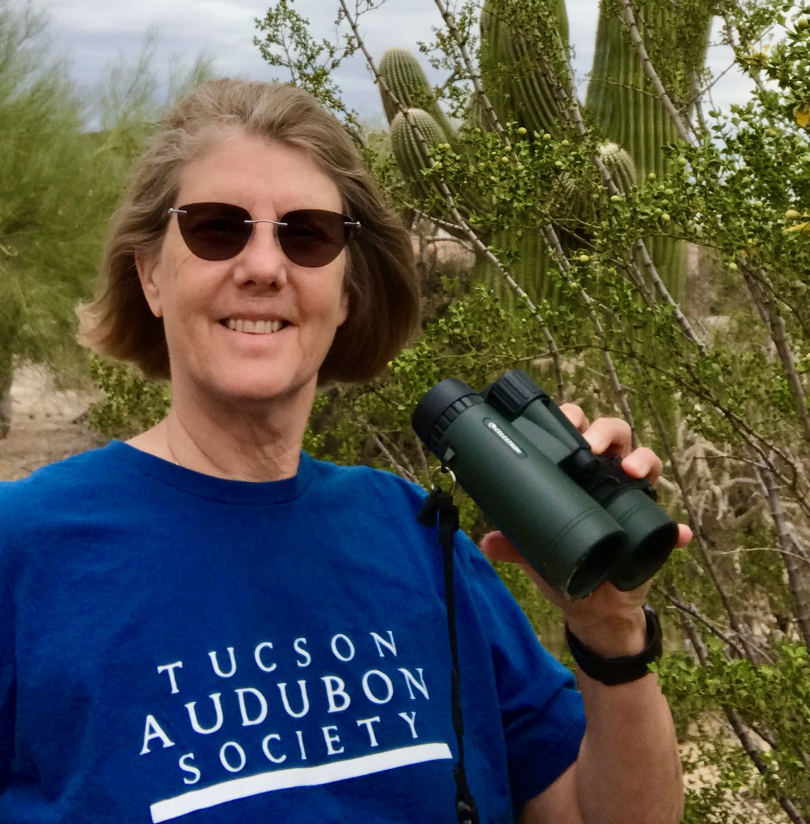 Photo of Peggy Steffens holding binoculars